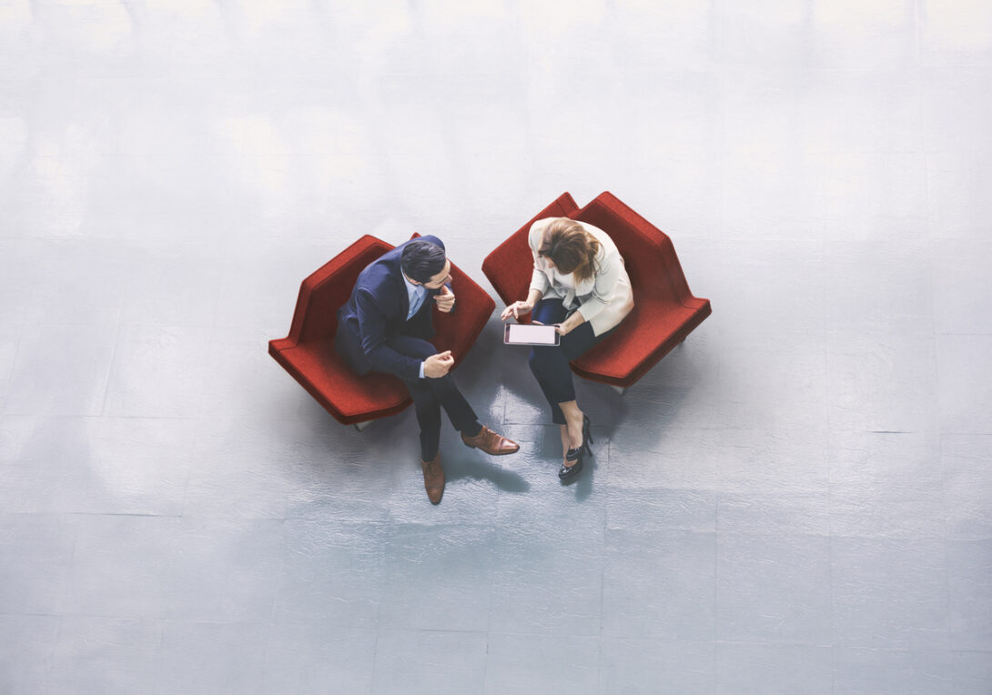 Overhead view of two business persons in the lobby Overhead view of two business persons in the lobby
